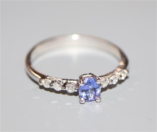 A modern 18ct white gold, tanzanite and diamond dress ring, size O.